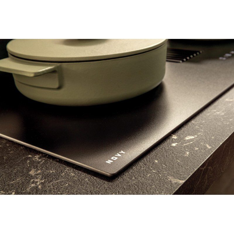 Plaque de cuisson noire avec casserole verte.