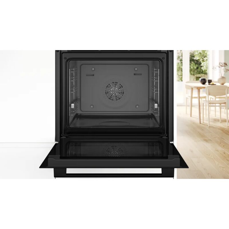 Four encastrable noir porte ouverte en cuisine moderne
