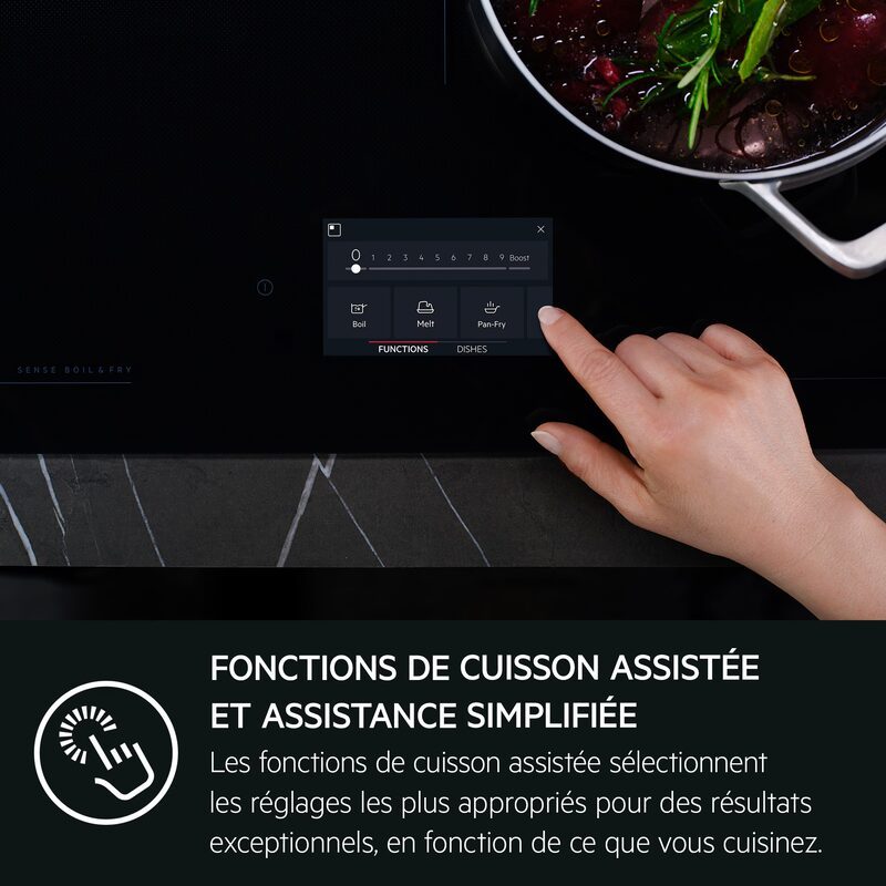 Main réglant plaque de cuisson tactile moderne