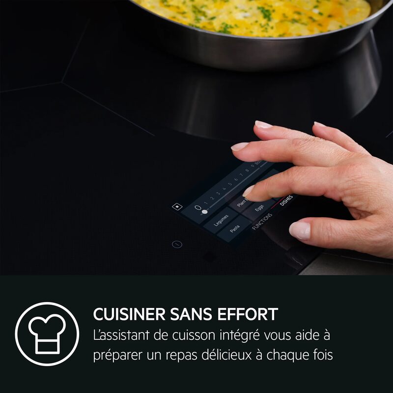 Main réglant une plaque de cuisson tactile moderne